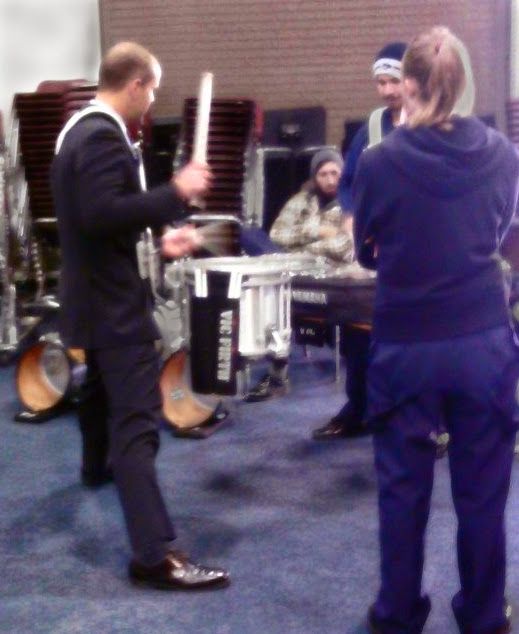 Dr. Shuey playing marching snare drum with students