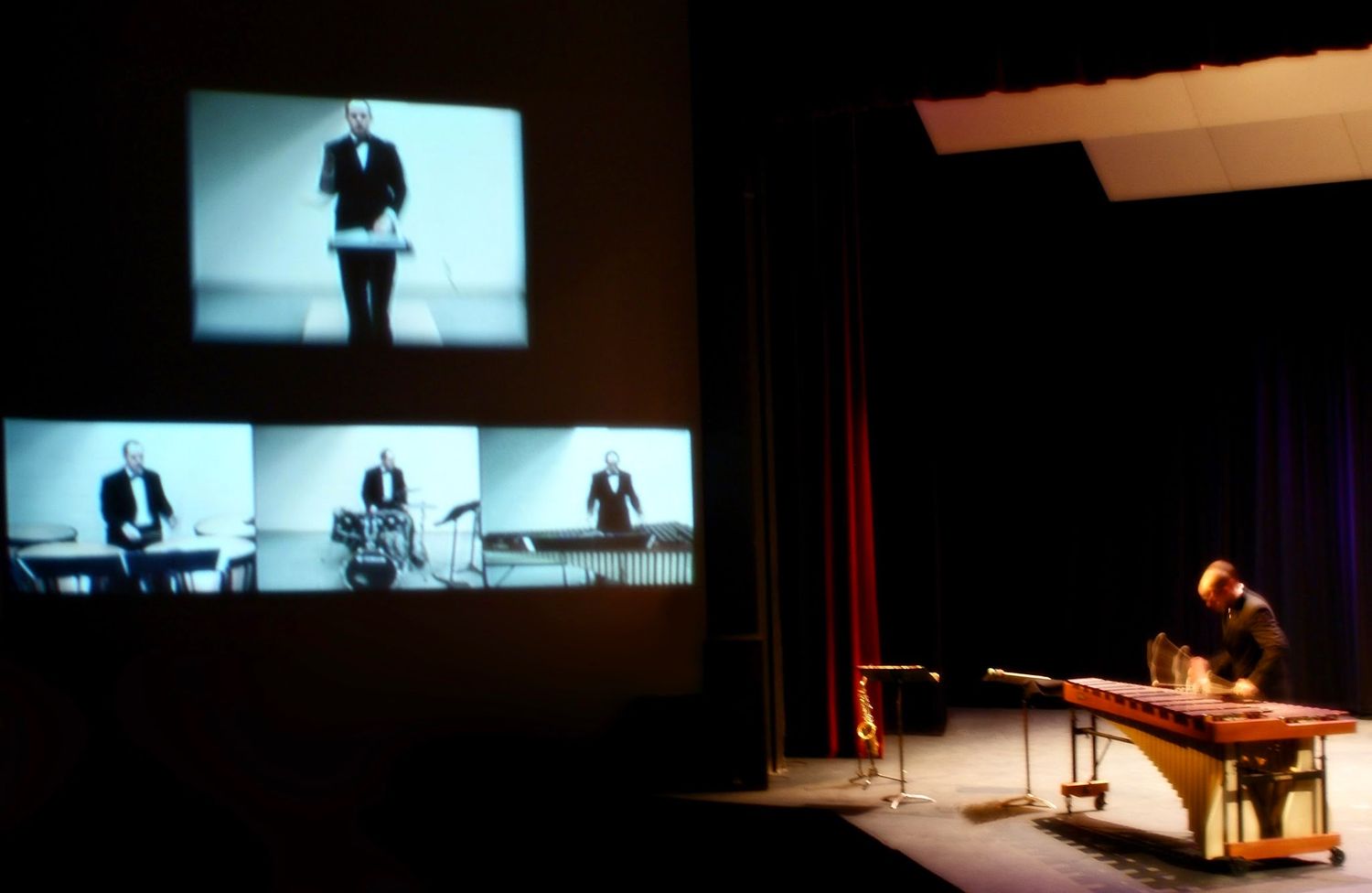 A marimba concerto, with the soloist shown on screens above the stage