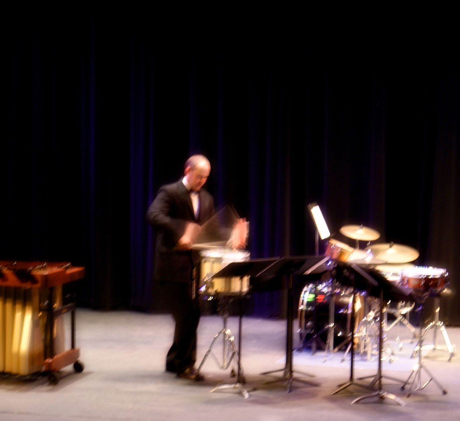 Dr. Shuey performing on a stage set with marimba, drums, and cymbals