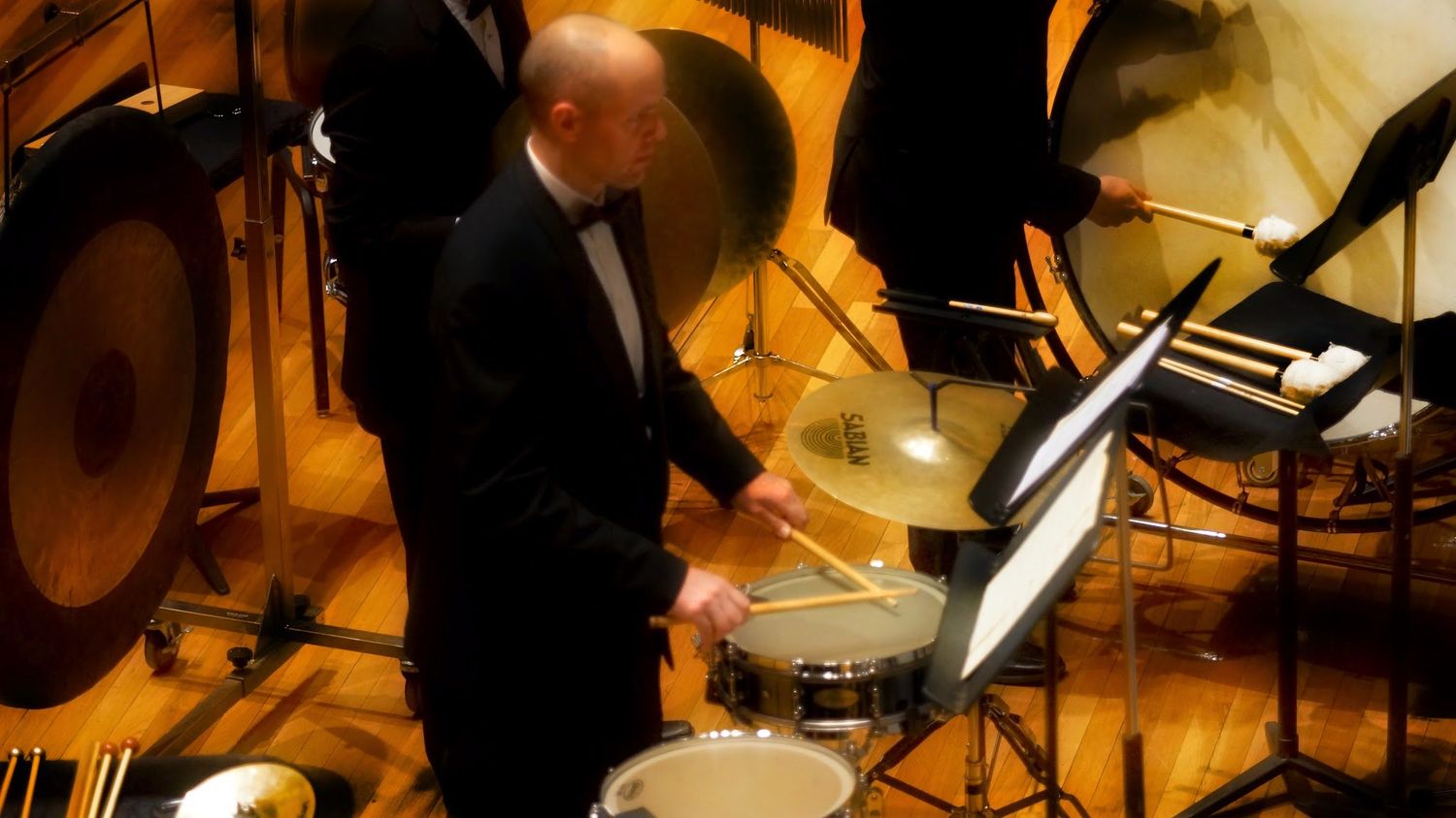 Dr. Shuey playing snare drum in an orchestra