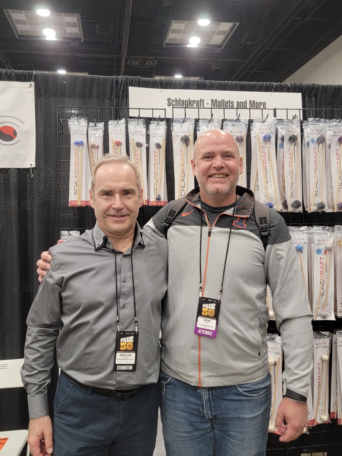 Dr. Shuey with a colleague at a mallet maker's booth at PASIC 2025