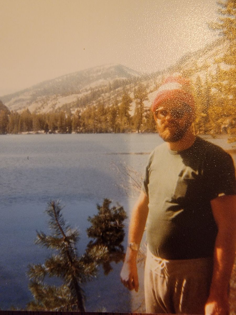 Paul Shuey beside a mountain lake