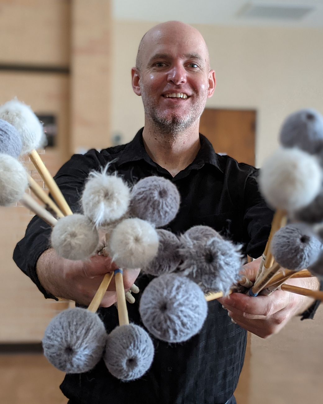 Trent Shuey holding a handful of marimba mallets