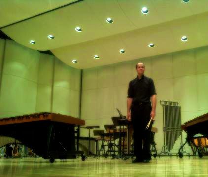 Dr. Shuey on stage with snare drum sticks