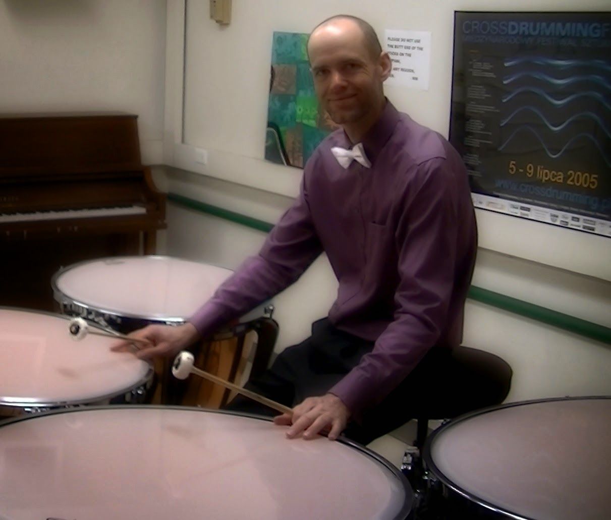 Dr. Shuey playing timpani in a practice room