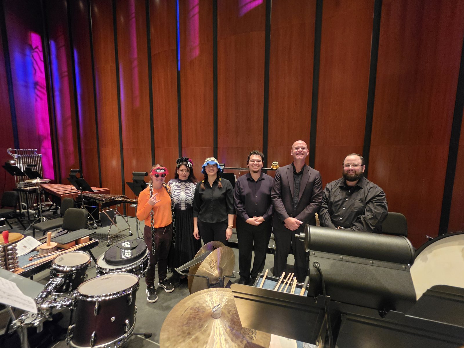 The West Texas Symphony percussion section, some in Halloween masks, October 2026